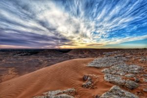 Desert_dand_and_clouds_moving_in_blue_sky